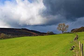 Dark clouds gather across the walk to Bamford Edge, Derbyshire