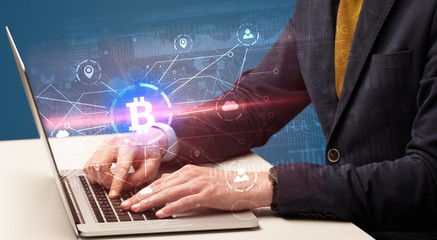 Fototapeta na wymiar Hand checking on laptop global bitcoin exchange rate concept 