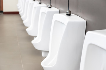 Outdoor row of urinal toilet blocks in public restroom