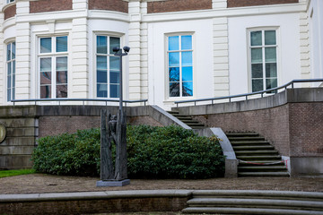 Fototapeta na wymiar Den Haag, Netherlands, , a bench in front of a brick building