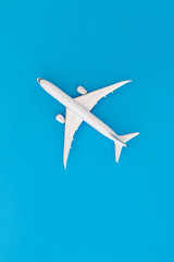 Model airplane on blue pastel color background,Top view