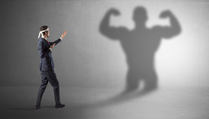 Fototapeta premium Businessman fighting with his bossy yelling shadow 