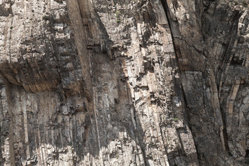 Rough layered natural rock wall, background