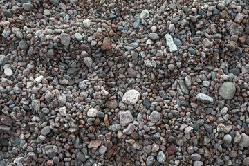 Dark pebble on a sea coast, close up photo