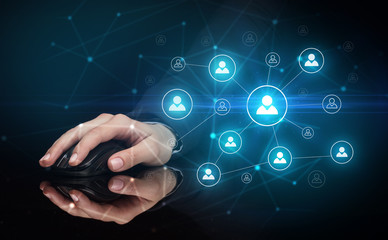 Hand using wireless mouse in a dark environment with human network concept