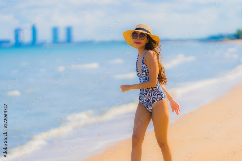 Wall mural portrait beautiful young asian woman happy smile relax on the tropical beach sea ocean for leisure t