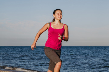 Beautiful girl runs along seashore