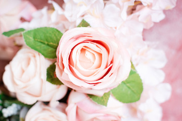 Artificial pink roses in soft focus background