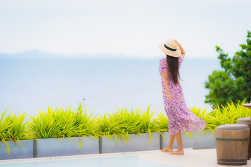 Portrait beautiful young asian woman looking at sea ocean with happy smile for relax leisure in vacation