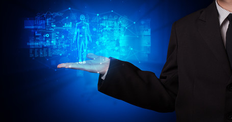 Young person holding hologram projection displaying health related graphs and symbols
