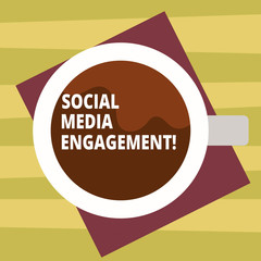 Text sign showing Social Media Engagement. Conceptual photo Communicating in an online community platforms Top View of Drinking Cup Filled with Beverage on Color Paper photo