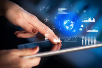 Hand holding tablet with global business concept
