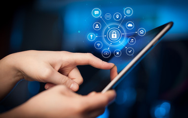 Hand holding tablet with online security concept
