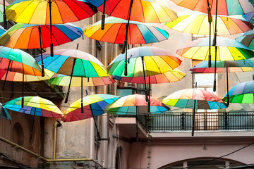 Fototapeta na wymiar Colorful umbrellas in the sky of the Victoria Passage, in Bucharest city centre, Romania