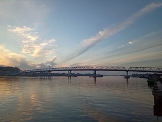 Fototapeta na wymiar the sky when the sun will rise in the river with the bridge