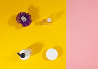 Bottles standing on a pink and yellow surface