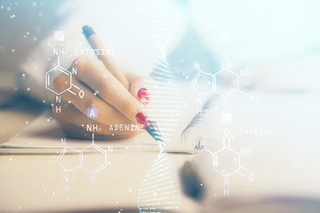 DNA theme hologram over woman's hands writing background. Concept of education. Double exposure