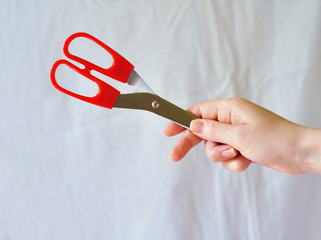 Small items in hand: scissors, paper heart, ball.