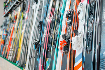 Rows of skis in sports shop, closeup, nobody