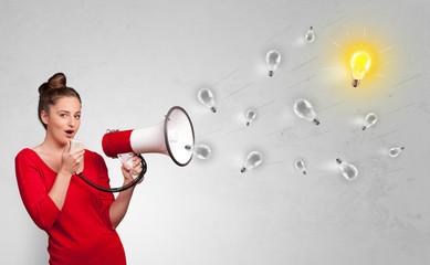 Person talking in megaphone with bulb, new idea concept
