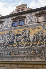 Public street view of the largest porcelain artwork in the world Furstenzug - Procession of Princess in Dresden, Germany, mural of a mounted procession of Saxony rulers