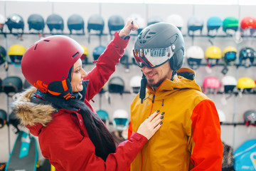 Couple check the strength of the ski helmet