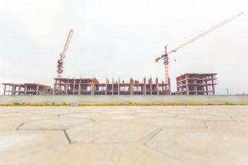 Fototapeta na wymiar Home construction. The builders and the crane do their job of building housing.