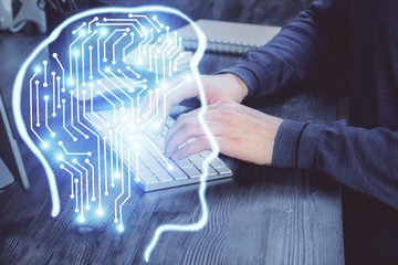 Man with computer background with brain theme hologram. Concept of brainstorm. Double exposure.