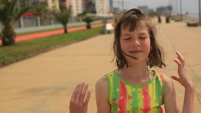 teen girl goes to the seaside from the beach after swimming