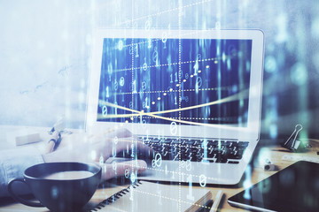 Double exposure of data internet theme hologram with man working on computer on background. Concept of innovation.