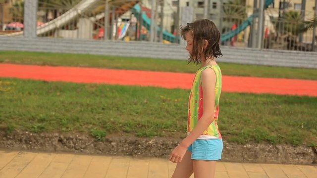 teen girl goes to the seaside from the beach after swimming