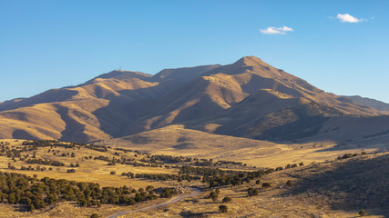 Panorama Scenic panorama of a mountain against light blue sky on a sunny day