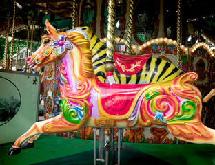 Vivid painted wooden fair horse from the side