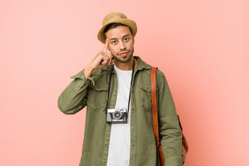 Young filipino traveler man pointing temple with finger, thinking, focused on a task.