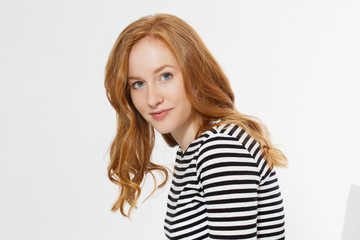 Naklejka premium Happy woman close up face isolated on white background. Red hair girl with curly hair. Skin care and teeth care. Copy space
