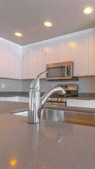 Panorama frame Modern kitchen of a new home with close up on the shiny faucet and sink