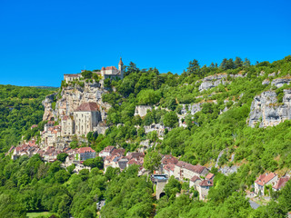 Fototapeta premium Foreground landscape view of the Dordogne tributary river valley cliff with the medieval french village of Rocamadour, Lot Department, Quercy, Occitanie Region, France. UNESCO world heritage site.