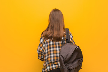 Young student woman from behind, looking back