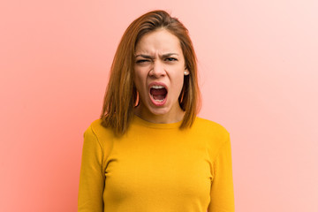 Young pretty young woman screaming very angry and aggressive.