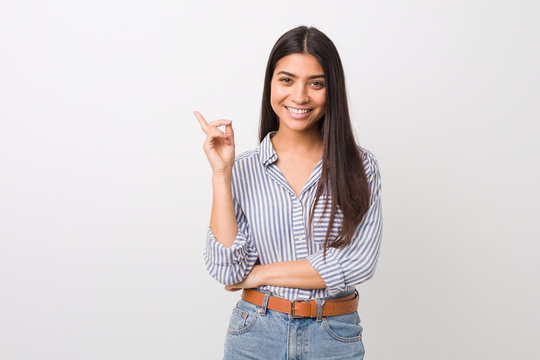 Young Pretty Arab Woman Smiling Cheerfully Pointing With Forefinger Away.