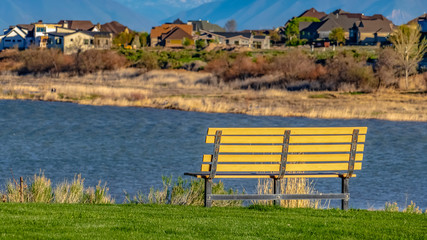 Panorama Bench with a scenic view of lake and snow capped mountain against blue sky