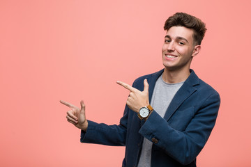 Young business natural man excited pointing with forefingers away.