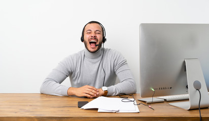 Telemarketer Colombian man shouting to the front with mouth wide open