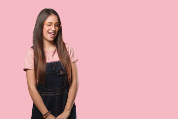 Young cool woman winking, funny, friendly and carefree gesture