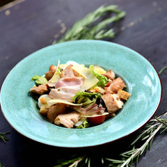 salad with fried bacon, parmesan, cherry tomatoes and crackers
