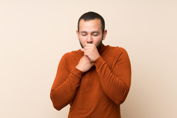 Colombian man with turtleneck sweater is suffering with cough and feeling bad