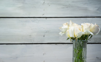 white roses on wooden background 