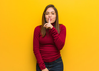 Young intellectual woman keeping a secret or asking for silence