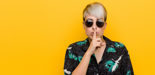 Young curvy woman wearing a summer look keeping a secret or asking for silence.