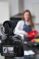 Fototapeta na wymiar Female Vlogger Making Social Media Video About Cooking For The Internet